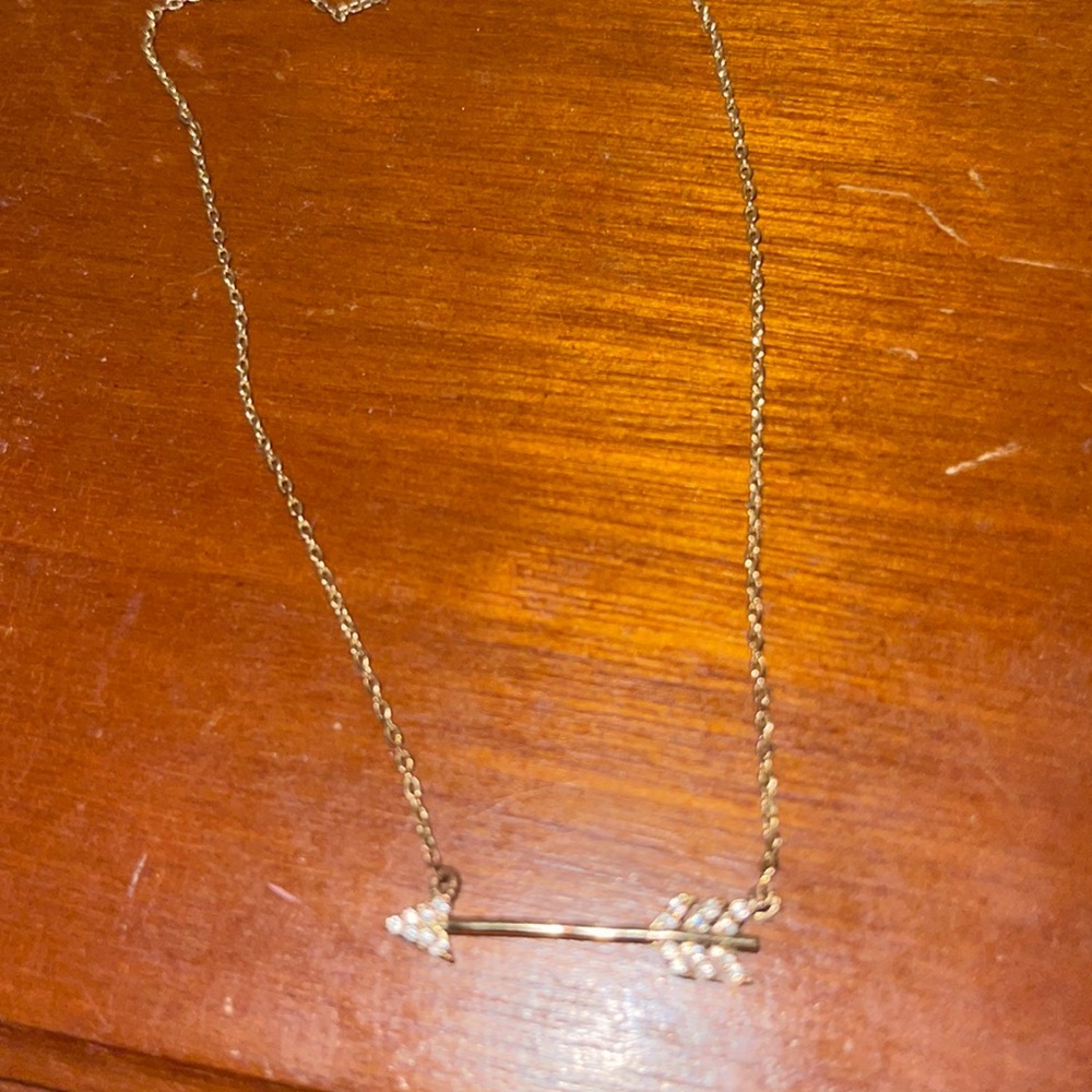 Gold bow and arrow necklace